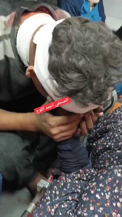 A child kissing his mother&rsquo;s hand: Please stay with me after their home was bombed by israel in Gaza