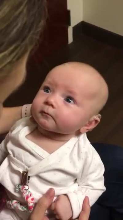 Baby hears mothers voice for the first time with the help of a hearing aid. the reaction is beautiful.