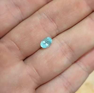 0.88ct 7.13x5.13mm, "paraiba" tourmaline (the real deal). A nice light Windex blue color, slightly included, unknown origin but I assume Mozambique or Nigeria. This stone has a commercial style cut but it's not windowed! A super special deal at $800 or be