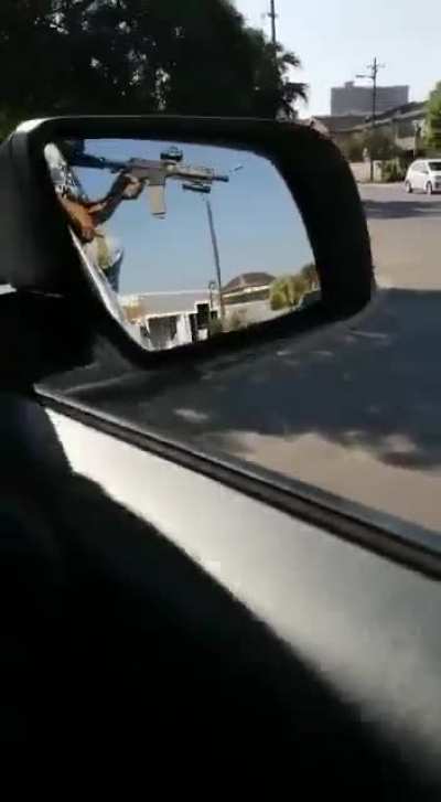 Vigilantes in South Africa driving through their neighborhoods and shooting at looters