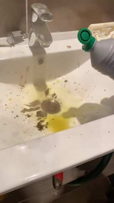 Pours &ldquo;drain cleaner&rdquo; into sink in an enclosed space