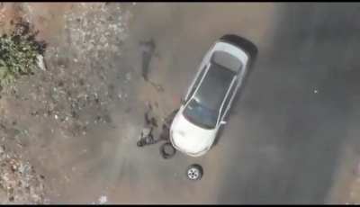 Sudanese drone attack on alleged RSF members changing a tire