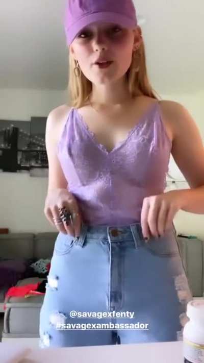 Meg in a purple bodysuit and orange bra