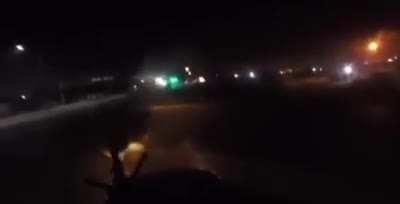 Mexican federal police officer firing on heavily armed members of the Cartel de Noreste (CDN) with a vehicle mounted M249 during a high speed chase in the streets of Nuevo Le&oacute;n, Mexico