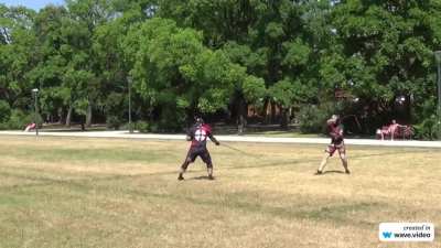 Two guys with whips sparring in the park