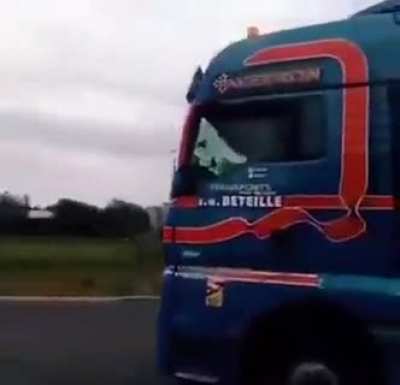 Trucker in a round-about with a goofy horn.