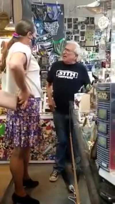 Store owner is confronted over transphobic sign