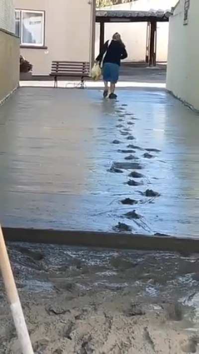 Lady decides to walk through wet cement