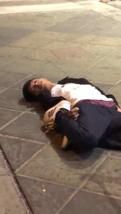 Guy gets choked out by security and lays folded like a pretzel until they pick him back up.