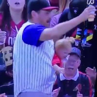 This guy let go of the baby momentarily to catch the ball then saved the baby and barely spilled a drop