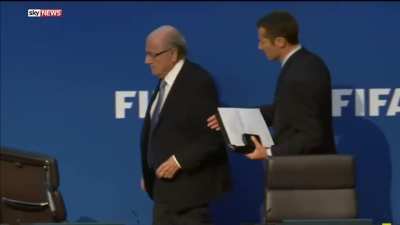 Corrupt former FIFA president Sepp Blatter gets money thrown at him during a press conference