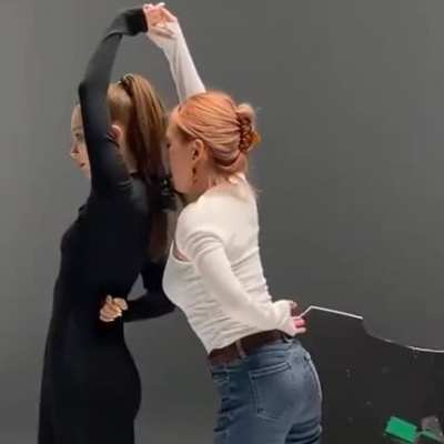 Holding the camera with her mouth and dancing.