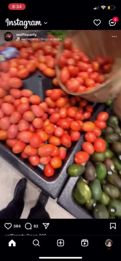Person spraying bug killer on fruits vegetables and chicken in a Walmart