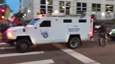 While the "tank man" of Tiananmen faced no threat or danger, and got away unharmed ... look how the American police state deals with protesters who block vehicles.
