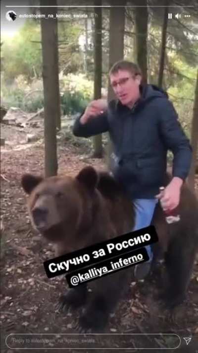 Russian man drinking vodka while riding a bear