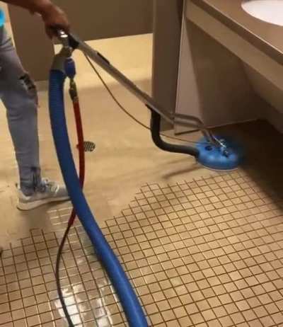 Cleaning the lines between the little tiles.