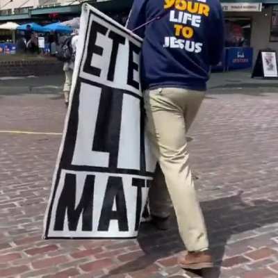 A woman grabs a speaker from a Christian hate preacher in Seattle and walks away.....