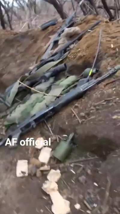 Ukrainian soldier films his fighting position, with some interesting clutter lying about.