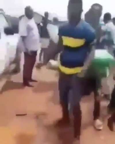 Ghanaian youths shout, We need jobs" as they reject bags of rice sent to them by their lawmaker.