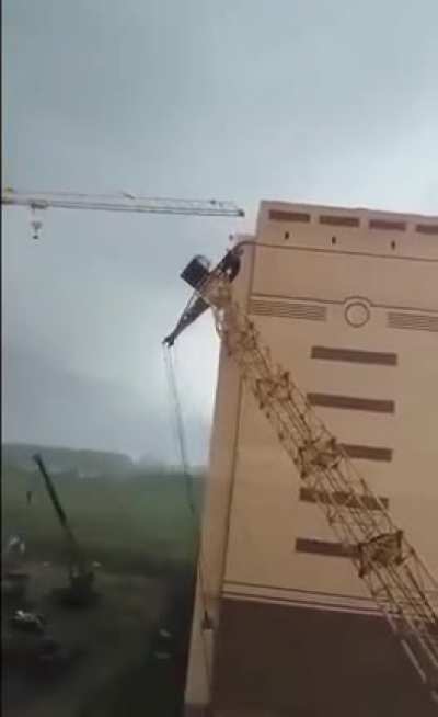 In Russia, Heavy wind knocks down cranes at a construction site