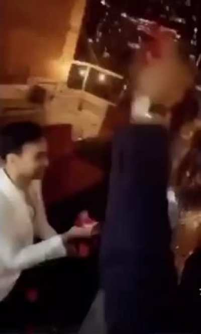 Man proposes to woman after which she grabs her phone to upload a picture on Instagram