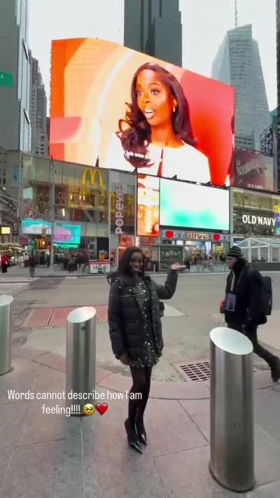 Olandria with her billboard in Times Square for her McDonald's campaign