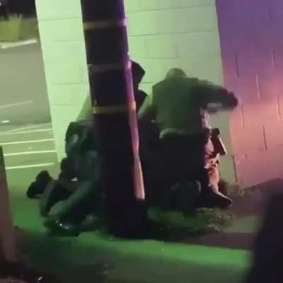 "Policemen" hiding behind a wall to beat the shit out of a man