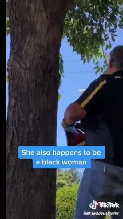 Man posts “No Trespassing” sign in front of a girl studying on a church lawn.