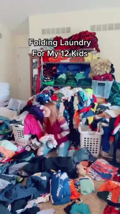 Folding laundry for her 12 children