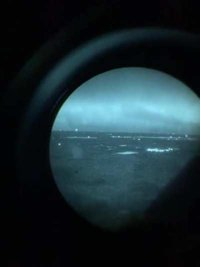 Aurora Borealis (The "Northern Lights") as seen through night vision goggles aboard an air ambulance helicopter.