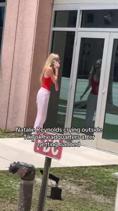 An influencer crying outside the TikTok headquarters, begging them to unban her account.