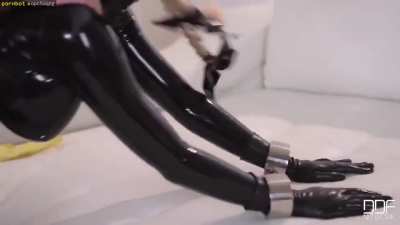 Latex-clad girl takes a strapon