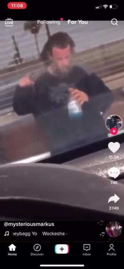 Bearded homeless addict snot rockets into Gatorade, then chooses to drink.