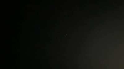 Last night While turning off the sprinklers I saw three unidentified flying objects. When I noticed them they were about 300 yards away sitting in the sky quietly not making a sound. The middle object turned off and then turned back on going dark for abou