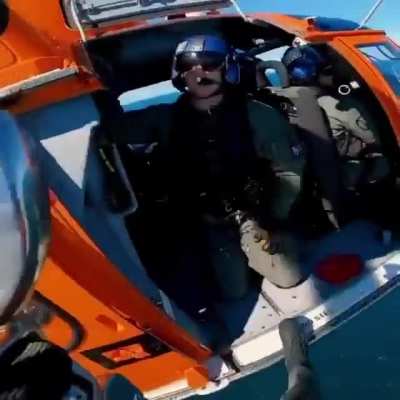 USCG rescue swimmer hoists down to an 800&rsquo;+ tall offshore windmill as part of a training evolution