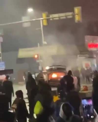 Crowd chants "burn motherfucker burn" as a police car is set on fire in Philadelphia during last night's riots