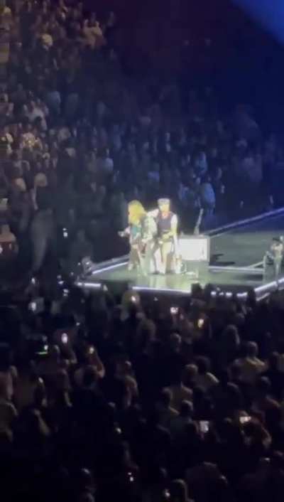 Madonna calls out someone for sitting down during her concert, then realizes the person is in a wheelchair 