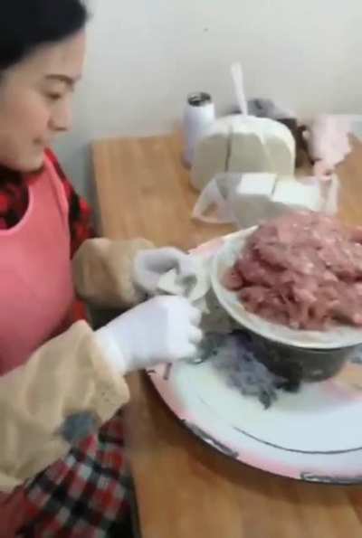 This woman wraps Wontons almost faster than I can watch.