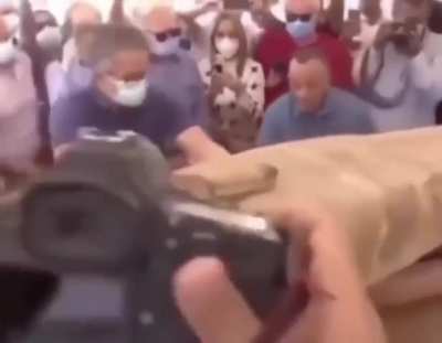 Dozens watched and filmed as this mummy coffin speculated to be more than 2500 years old is unsealed