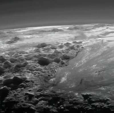 Wow, this is from freaking Pluto. Pluto&rsquo;s ice mountains, frozen plains and layers of atmospheric haze backlit by a distant sun, as seen by the New Horizons spacecraft.