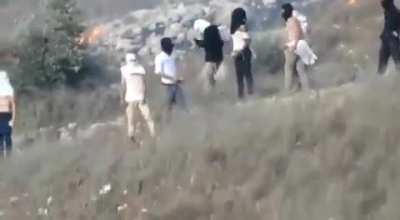 Illegal Jewish settlers with the presence &amp;amp; protection of the Israeli army set fire to Palestinian agricultural field as they also throw stones at the Palestinians