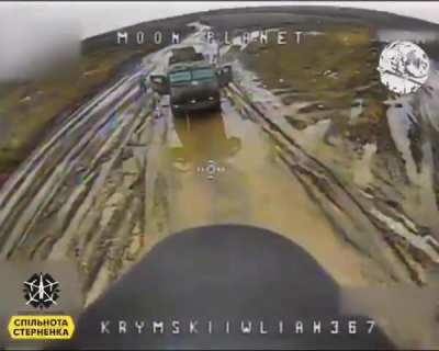 A Russian KAMAZ truck stuck in the mud is getting visited by a Ukrainian FPV quad. The crew flees as they notice the drone incoming. Geolocation: 49.0286, 38.1430 Kremenia, Luhansk Oblast.