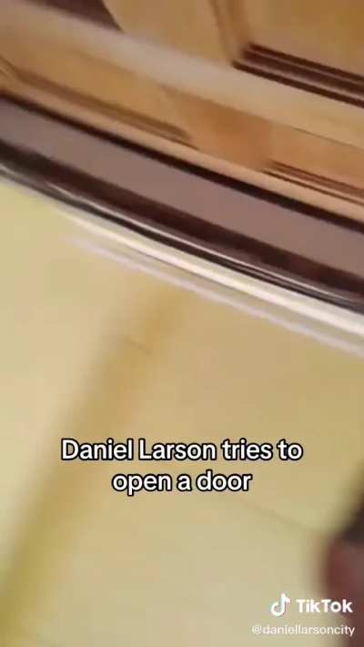 daniel larson tries to open the door