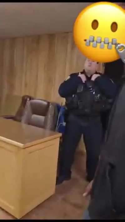 Men question cop who shot dog chained up behind a fence.
