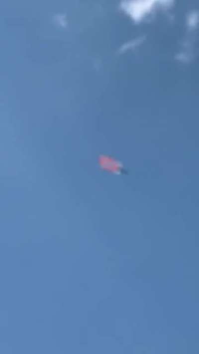 A confederate flag being flown over a NASCAR race.