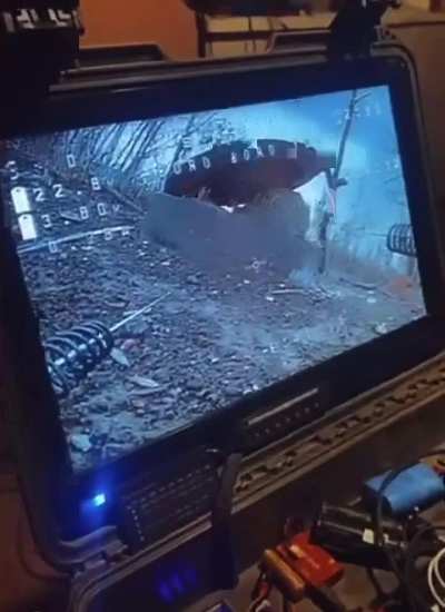 Russian coming out of a sewer gets eliminated from a Ukrainian drone laying on the ground