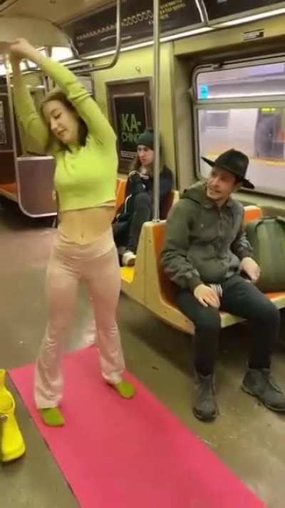 Girl takes off her pants and starts doing "yoga" on the NYC subway