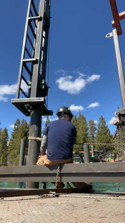 Pile driver installing pier piles on Lake Tahoe