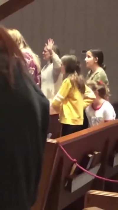Girl does macarena during prayer