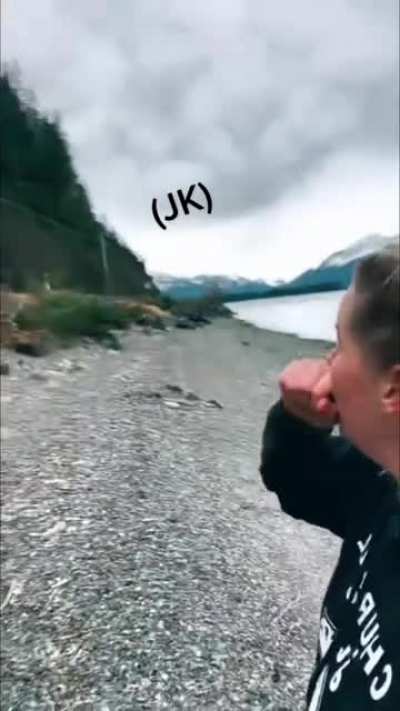 Alaskan guide talking about landslides as one happens above her.
